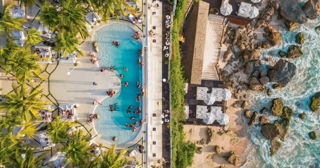 Bali didn't adopt the beach club, it perfected it. Here are the eleven clubs worth building a day around, from Seminyak sand to Uluwatu cliffs.
