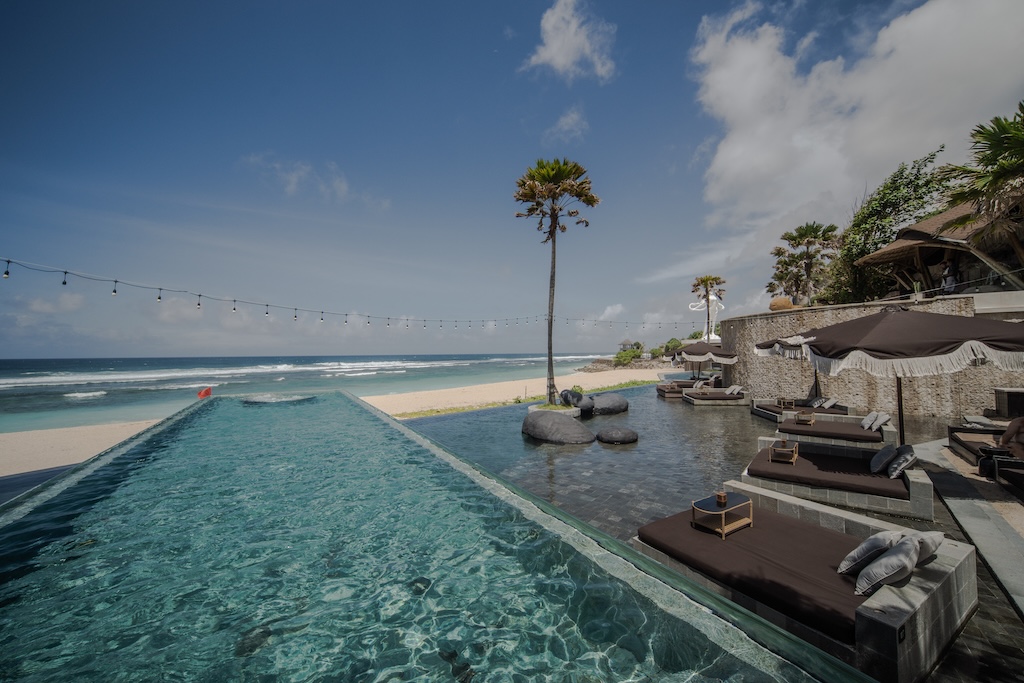 Bali didn't adopt the beach club, it perfected it. Here are the eleven clubs worth building a day around, from Seminyak sand to Uluwatu cliffs.