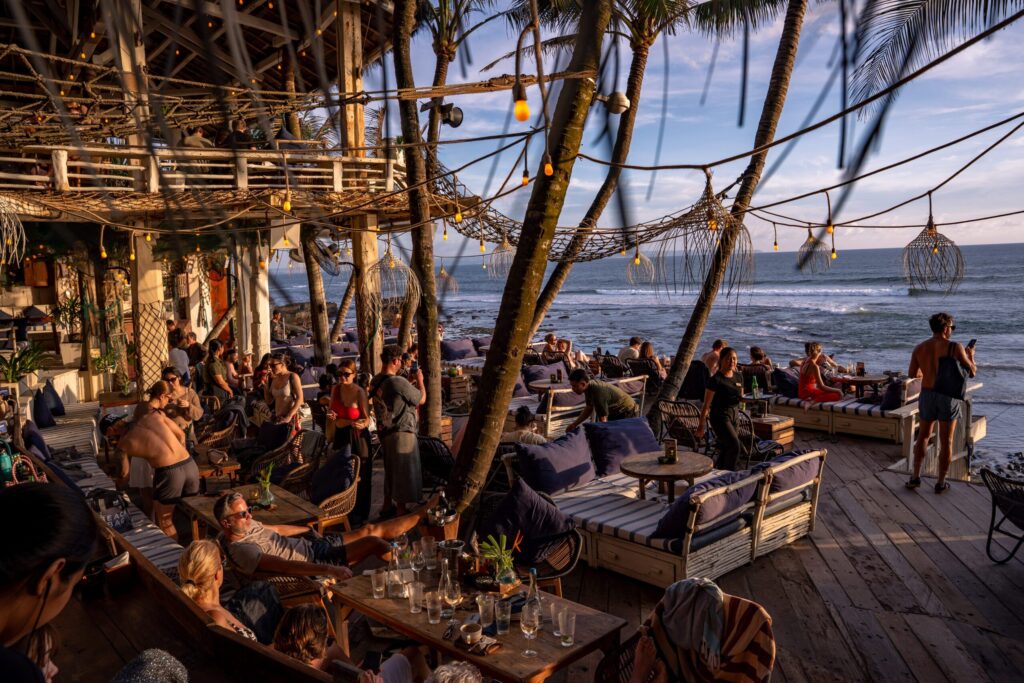 Bali didn't adopt the beach club, it perfected it. Here are the eleven clubs worth building a day around, from Seminyak sand to Uluwatu cliffs.